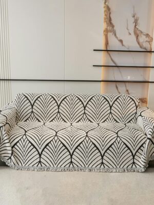 Modern sofa with stylish geometric slipcover in a sophisticated living room setting.